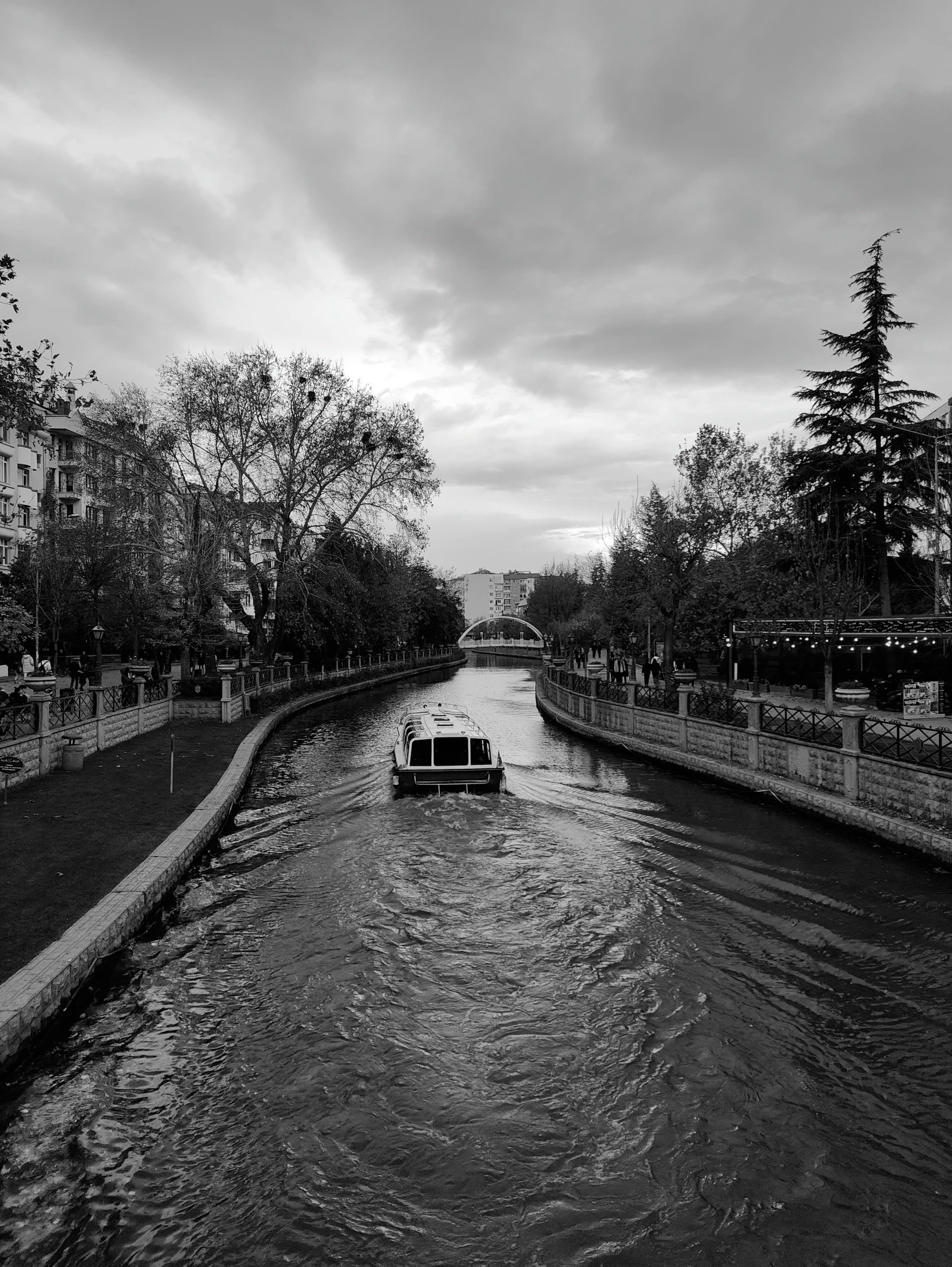 a black and white po shows the waterway in the evening