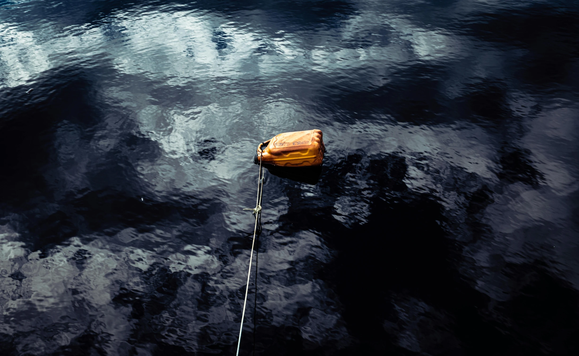 a string tied to a buoy with sky in background