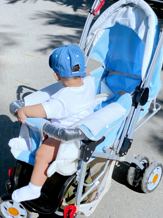 a small child riding on top of a white tricycle