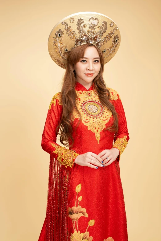 an asian woman wearing a hat with elaborate embroidery on it
