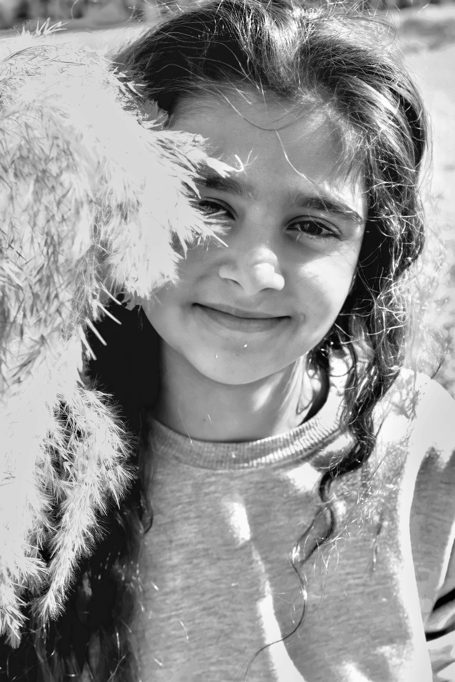 a little girl smiling while holding her dog's face