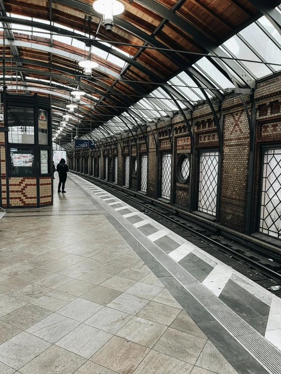 a train station with its doors open and people walking on the walkway