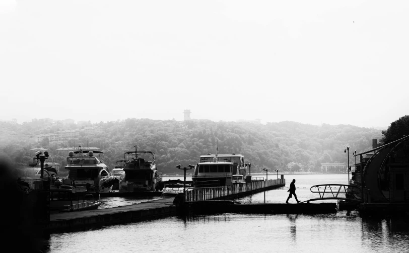 there are some buses on the pier in a lake