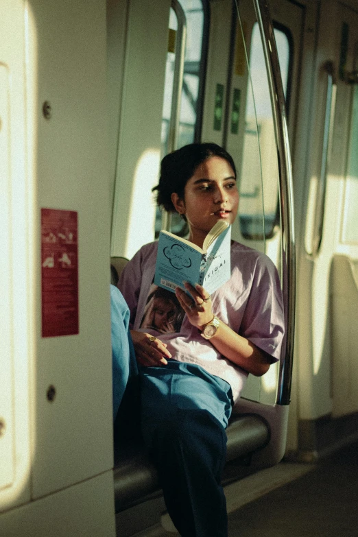 woman sitting on a train reading her book