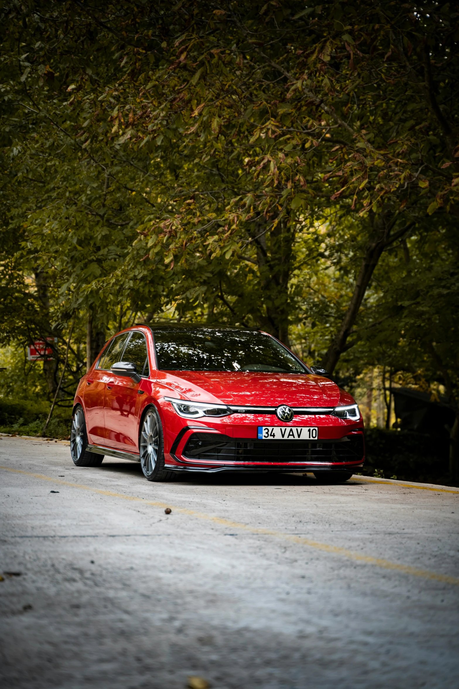 a red volkswagen car parked on the side of the road