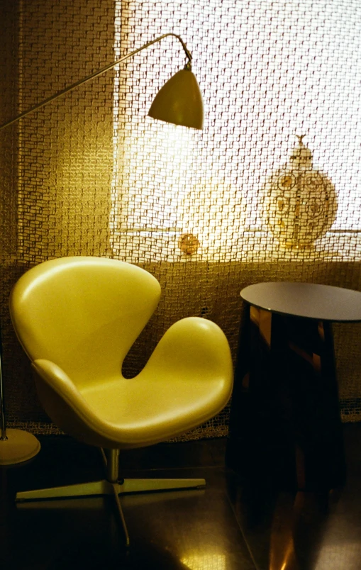 this room has yellow chairs and a lamp