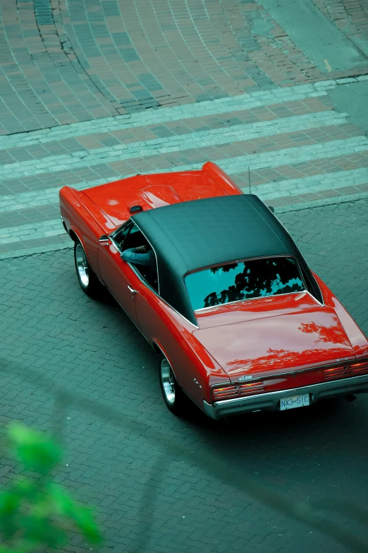 a red convertible parked on the side of a street