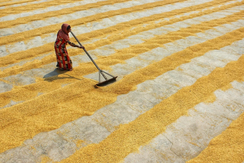 the woman is sweeping the floor with a broom