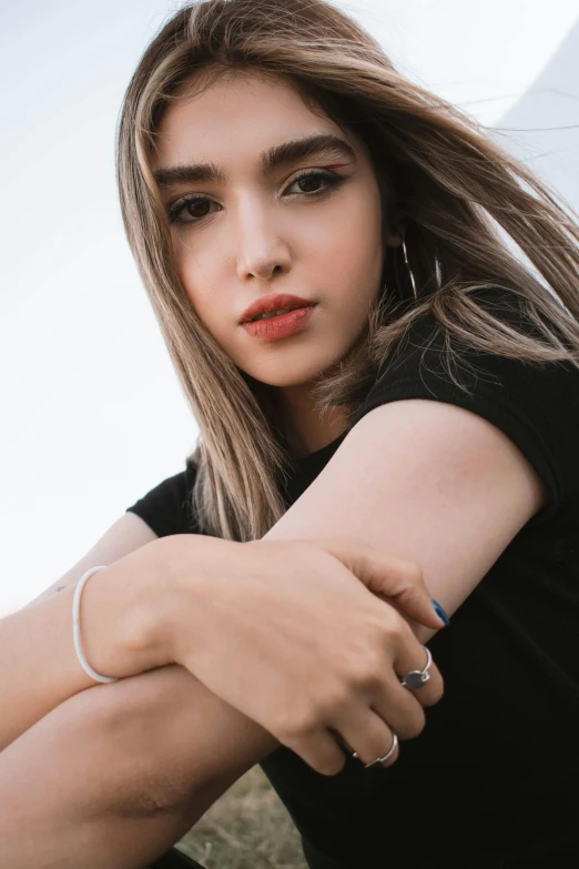 a girl with long brown hair is sitting