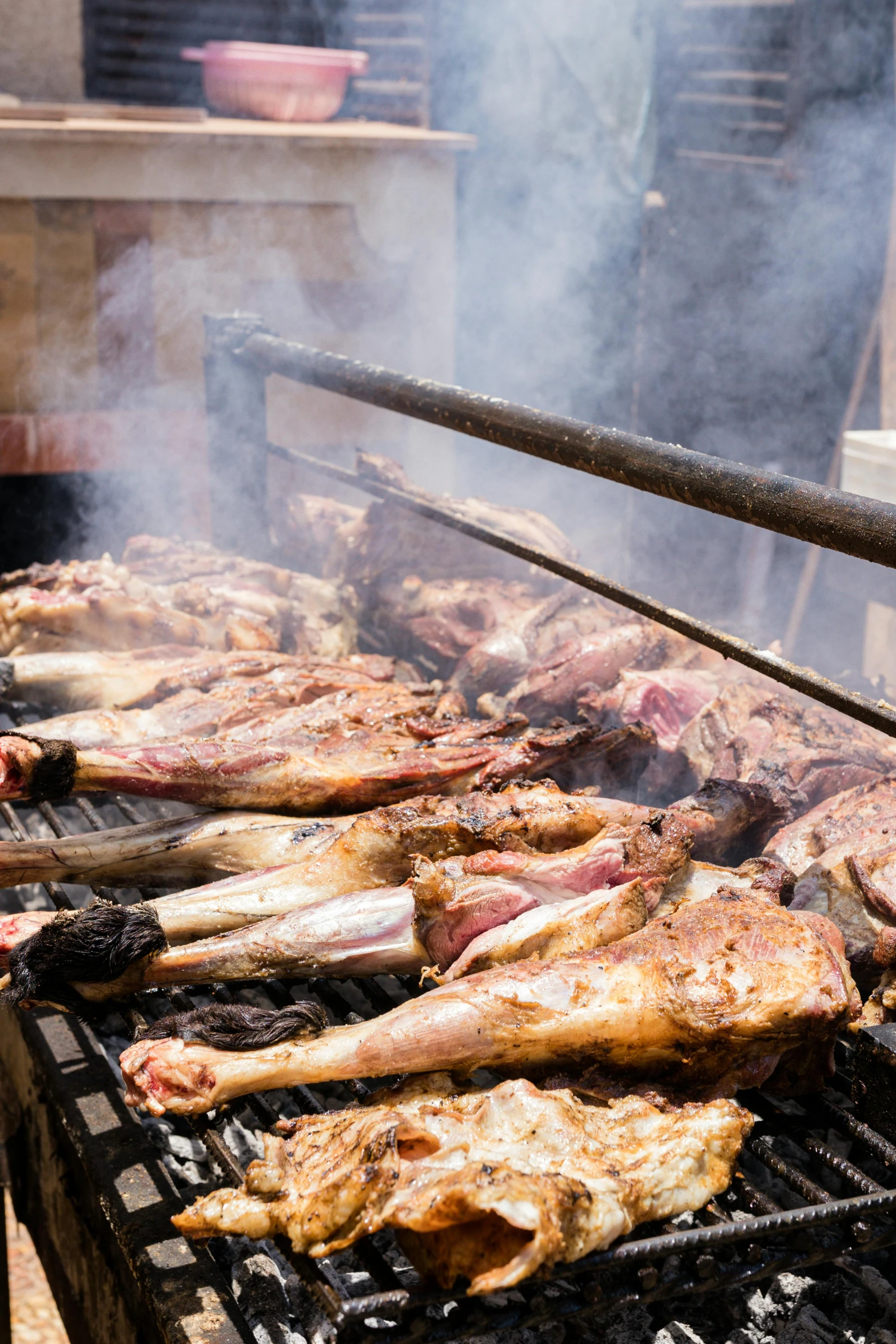 grill with several different items on top of it and water being poured over the bbq