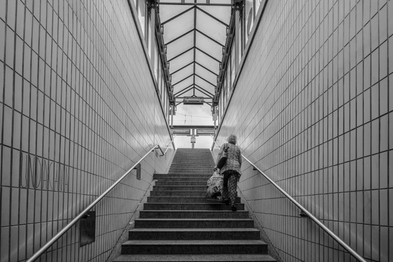 a person walking up stairs in an architectural building