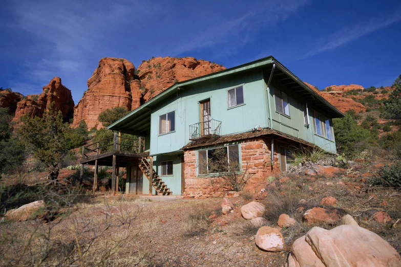 an old house that has rocks outside of it