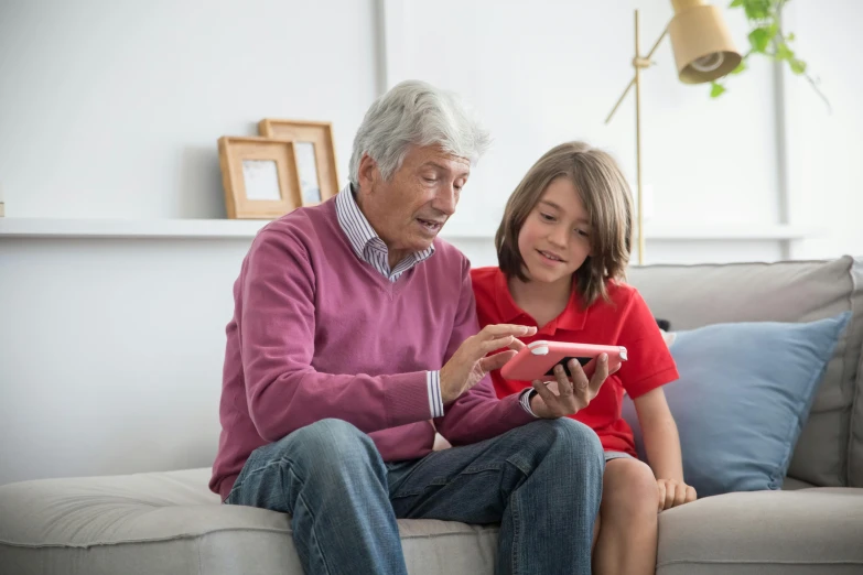 an older man and a  looking at a phone