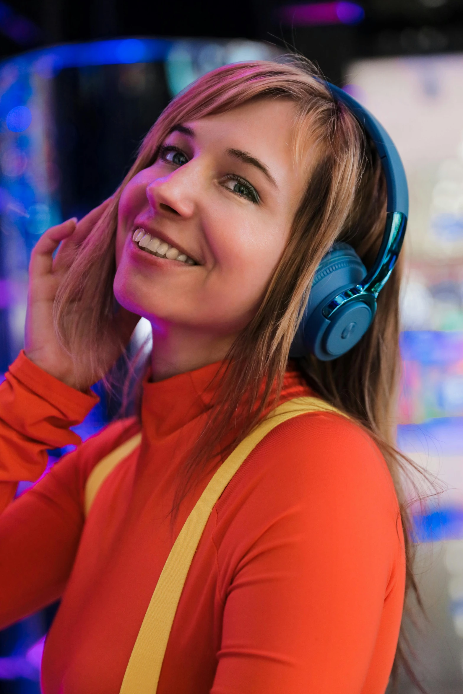 a young woman smiles and listens to music