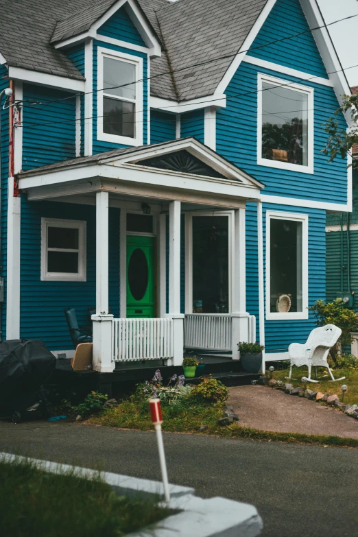 a house with blue siding and green door
