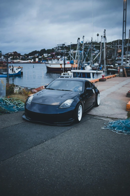 a black car parked near a marina