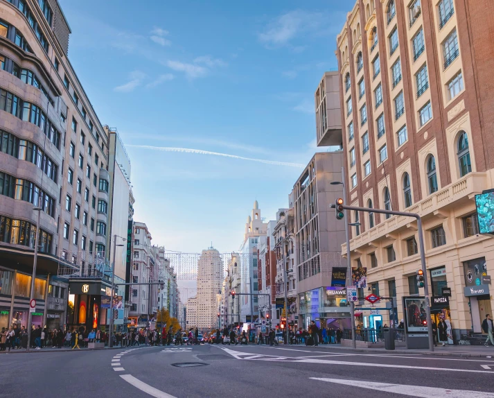 a very wide city street with tall buildings