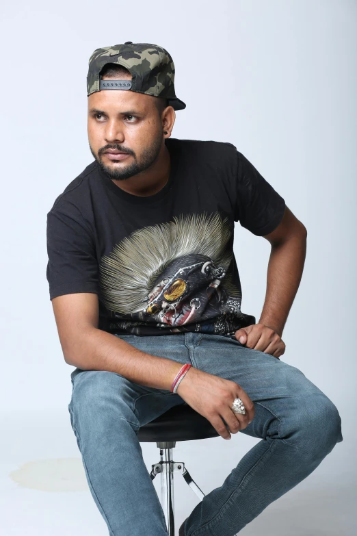 a man sitting in a chair with a tattoo on his arm