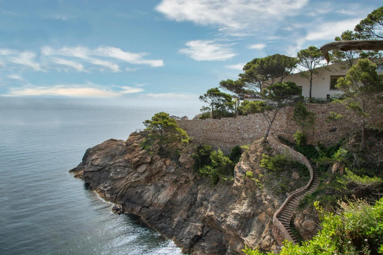 the building on the cliff by the water