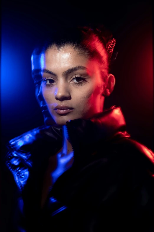 a woman in leather jacket with blue and red lights