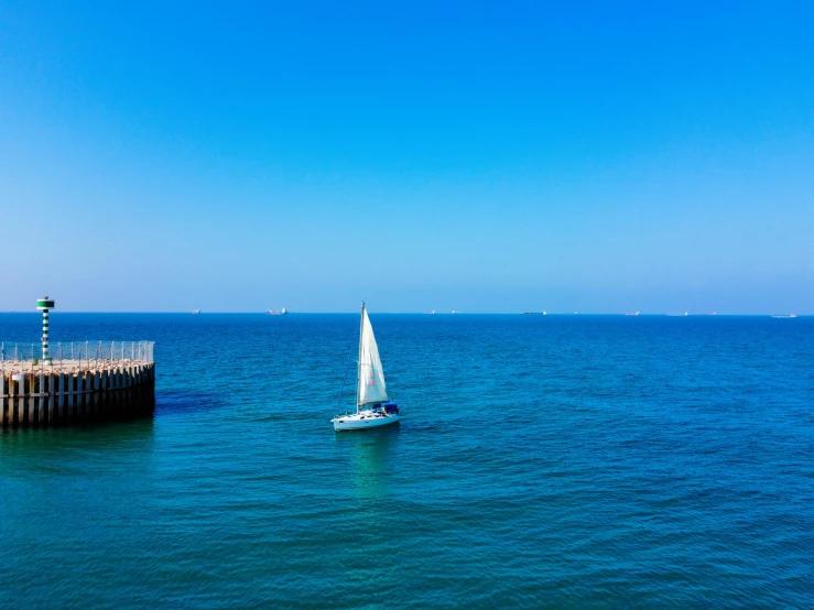 there is a sailboat that is out in the open water