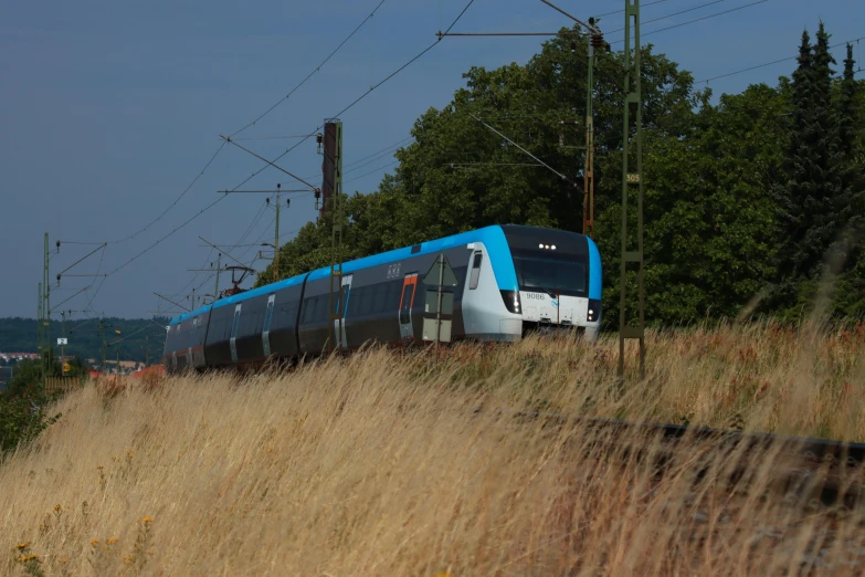 a train moving down tracks next to trees