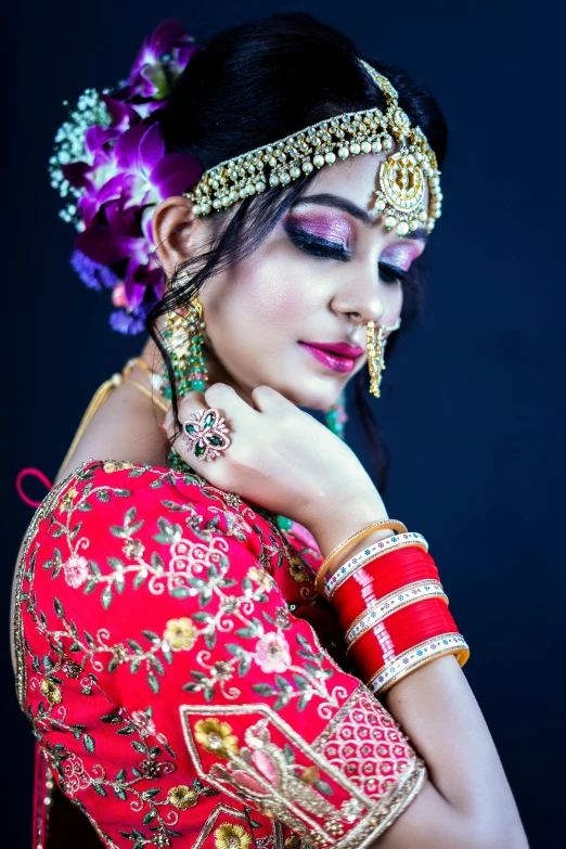 a woman wearing a bright red dress posing with a flower in her hair