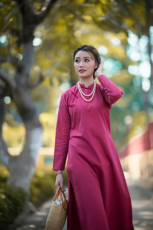 the woman is standing in front of some trees