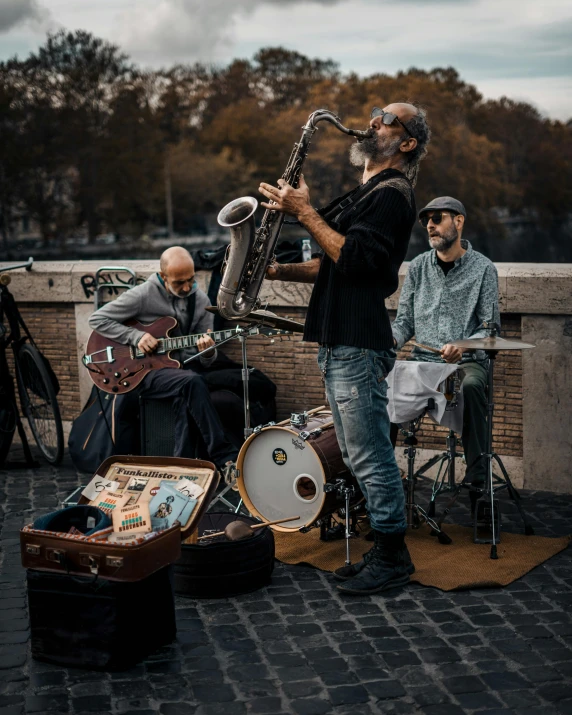 three musicians are playing the music on a balcony