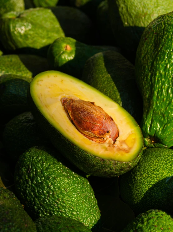 the green avocado has been cut and sliced