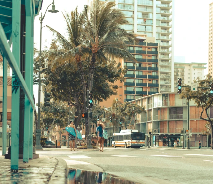 a busy city street with tall palm trees