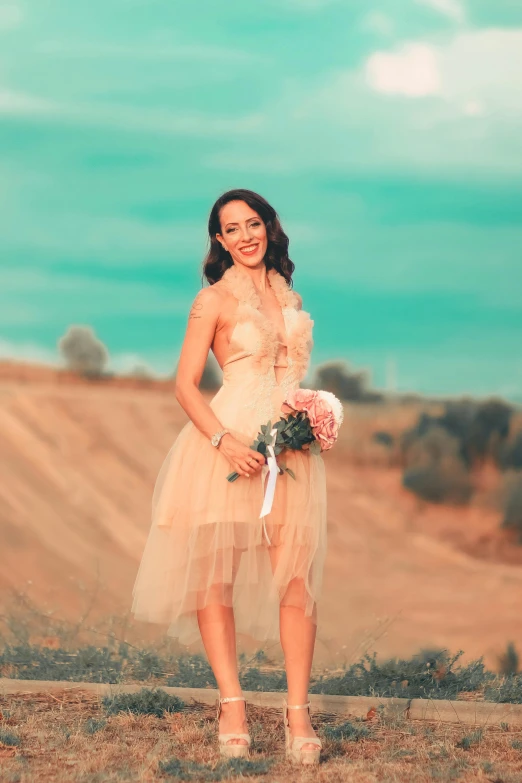 a woman standing in the desert posing for a picture