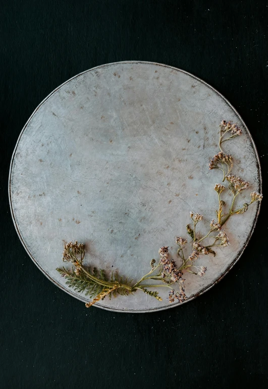 an empty dish with gold flowers on top