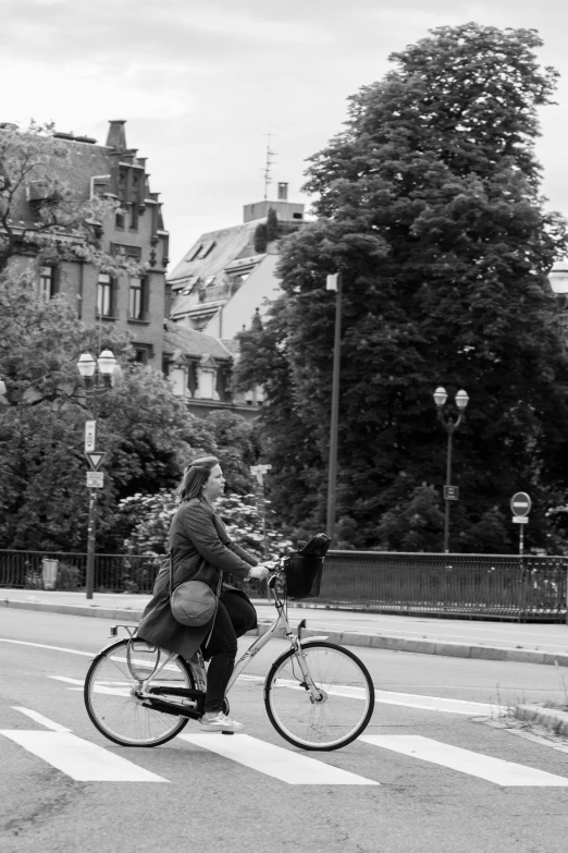 a woman is riding her bike across the street