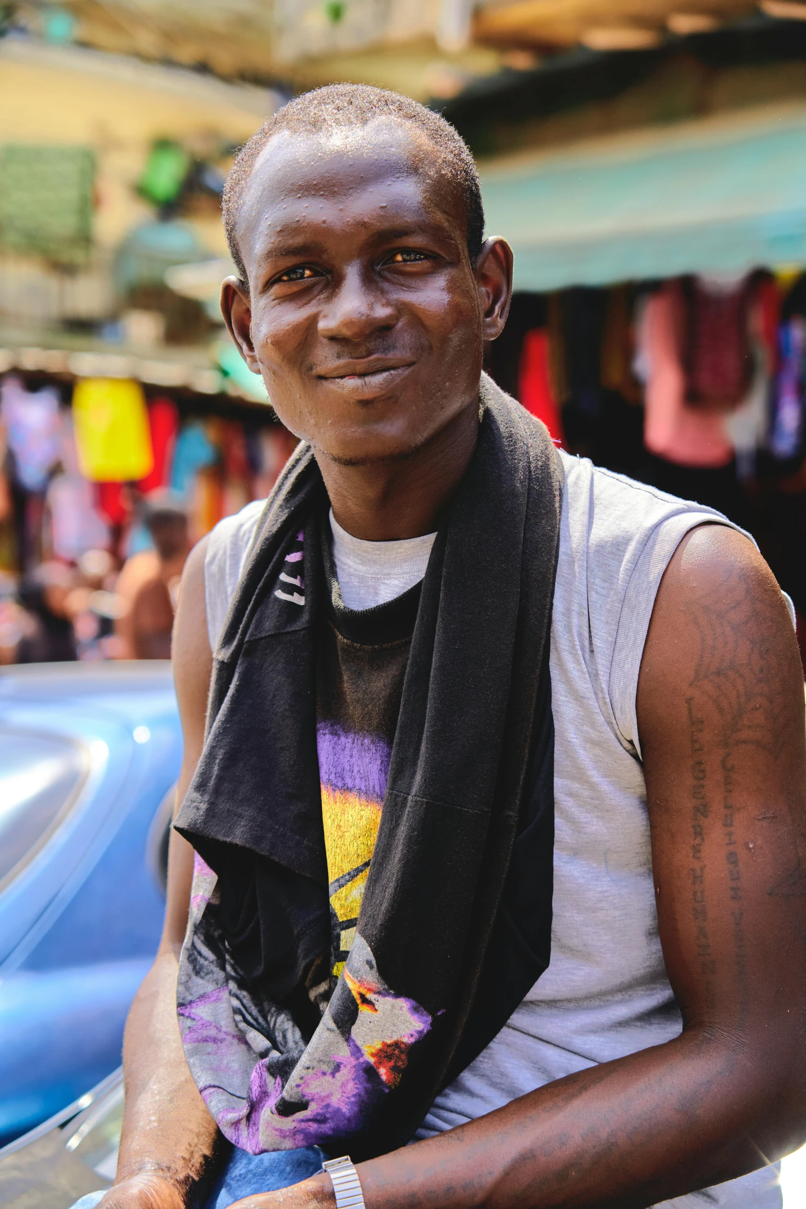 an elderly man poses for a picture in the street