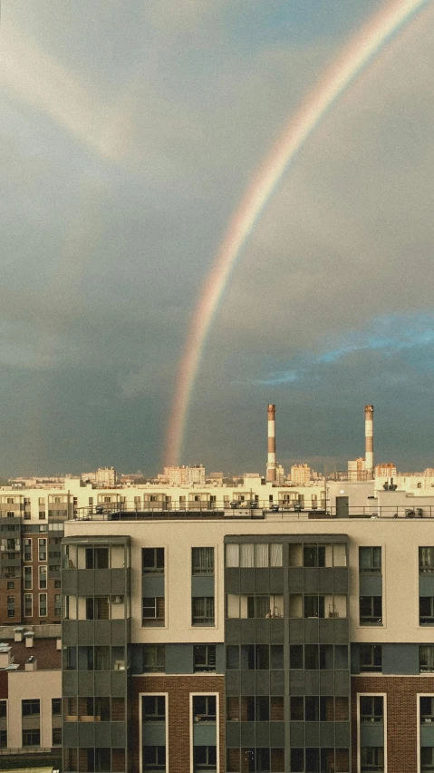 there is a rainbow over a large apartment building