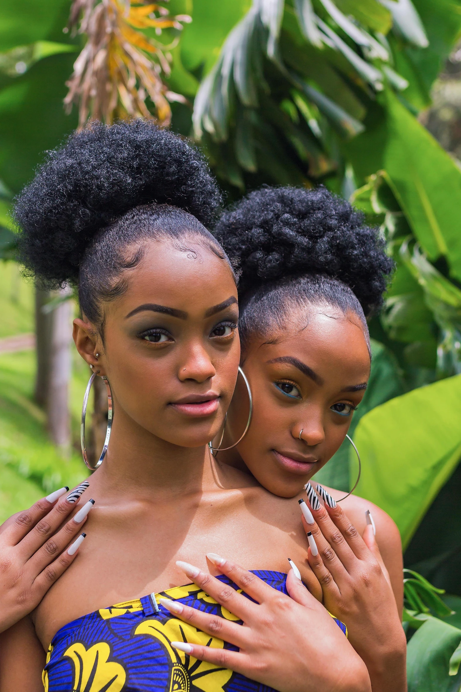 two beautiful women in short dress and big hoop earrings