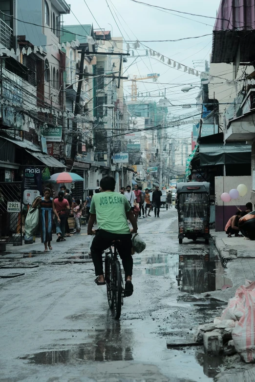 a person riding a bike through a rain soaked street