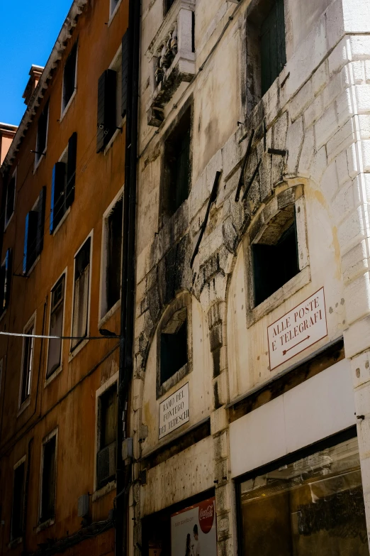 an old run down brick building with several small window