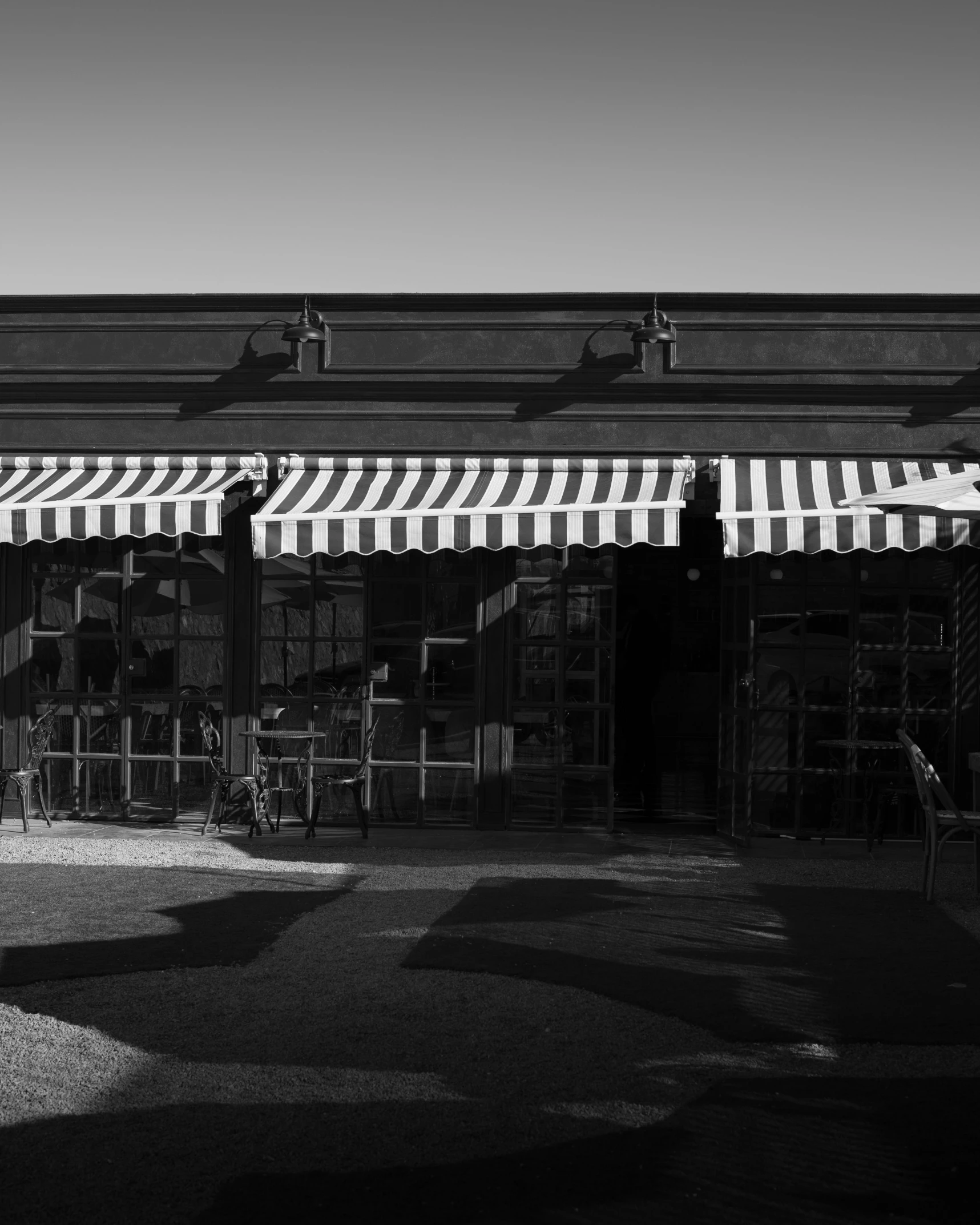 a storefront with awnings open on a sunny day