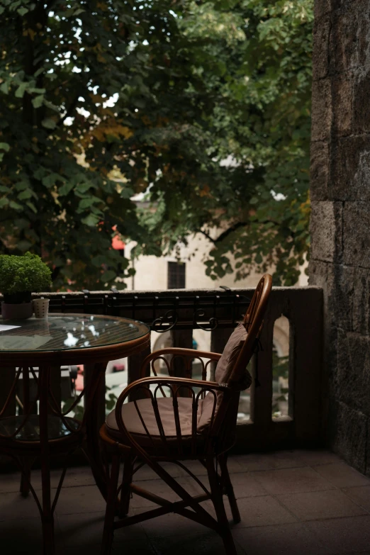 chairs and table on a porch looking at the water