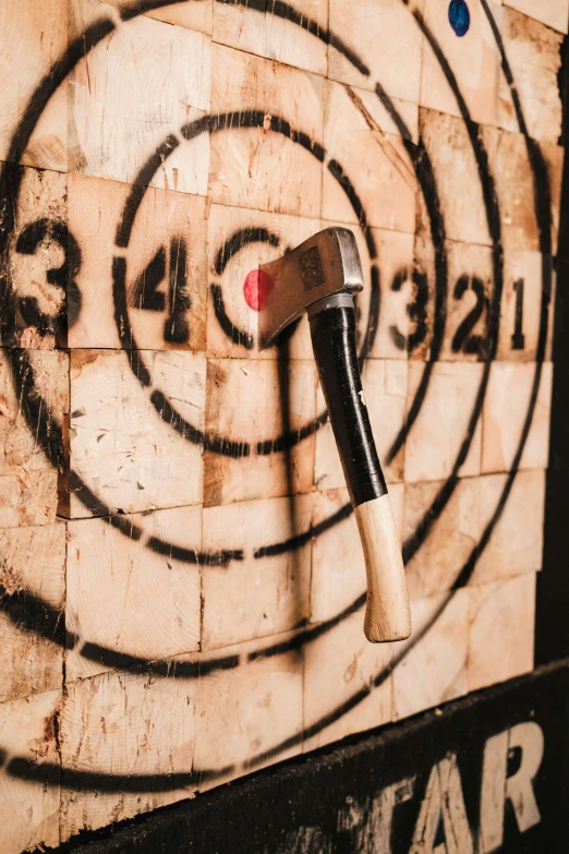 a hammer that is sticking into the middle of a wall