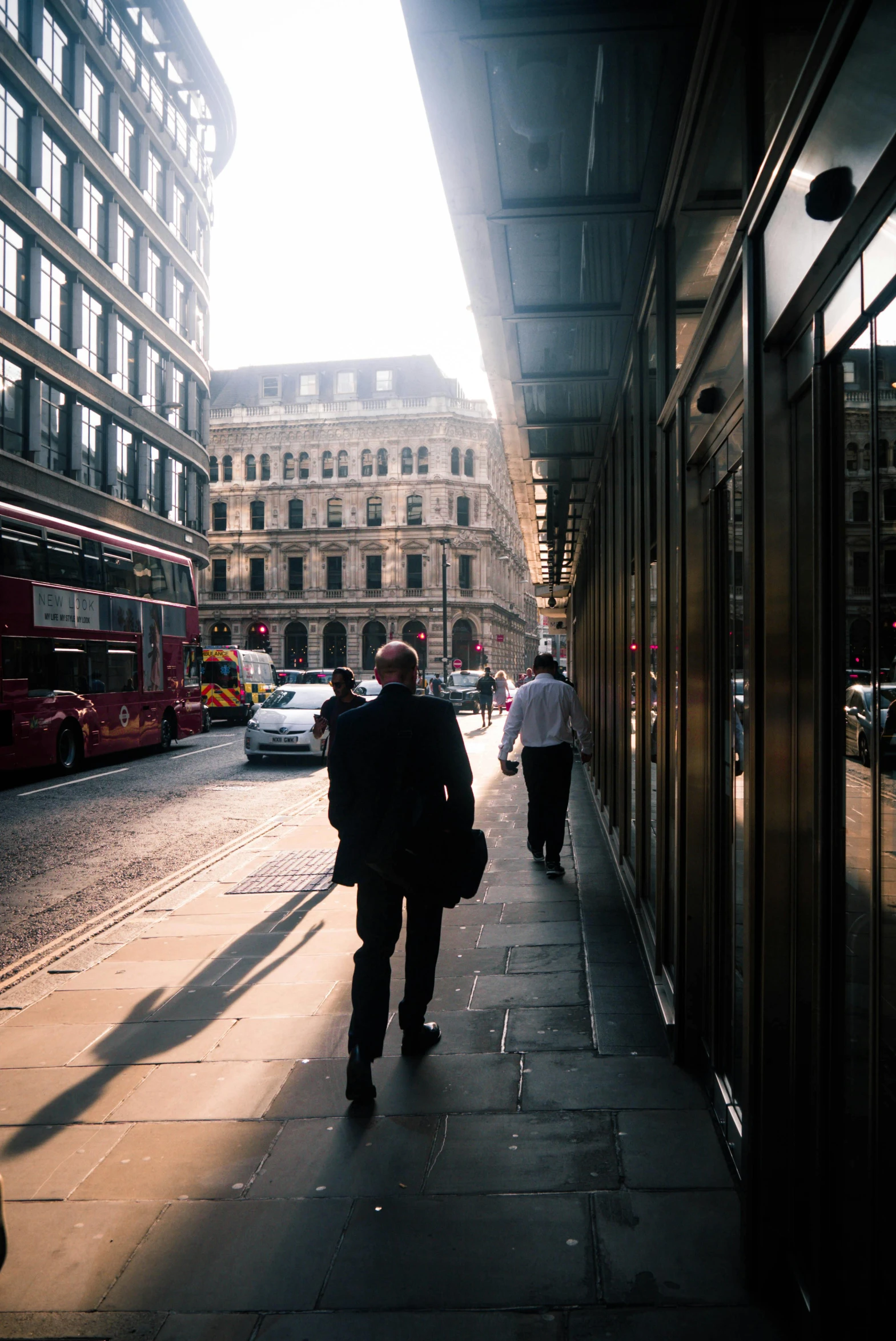 a man with a bag is walking down the sidewalk