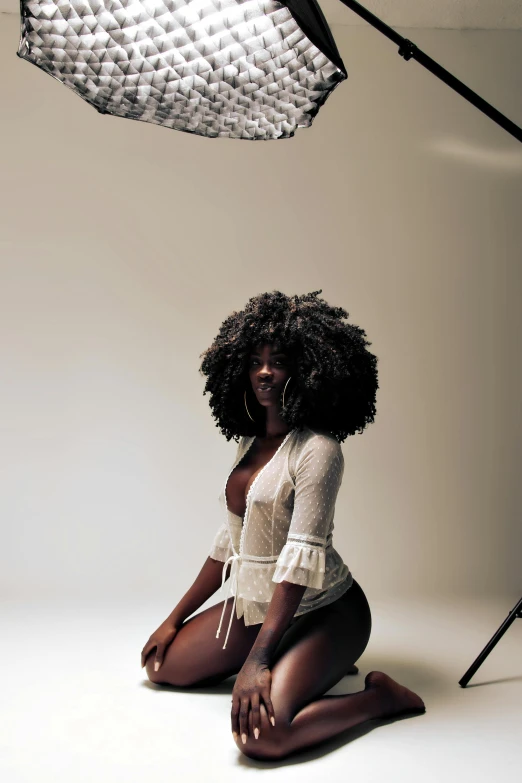 a beautiful young lady sitting down in front of a camera