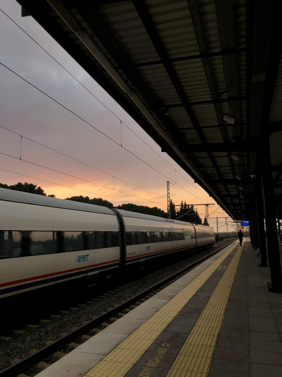 a train sitting on a track near a station