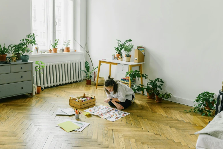 a woman is sitting on the floor in an empty room