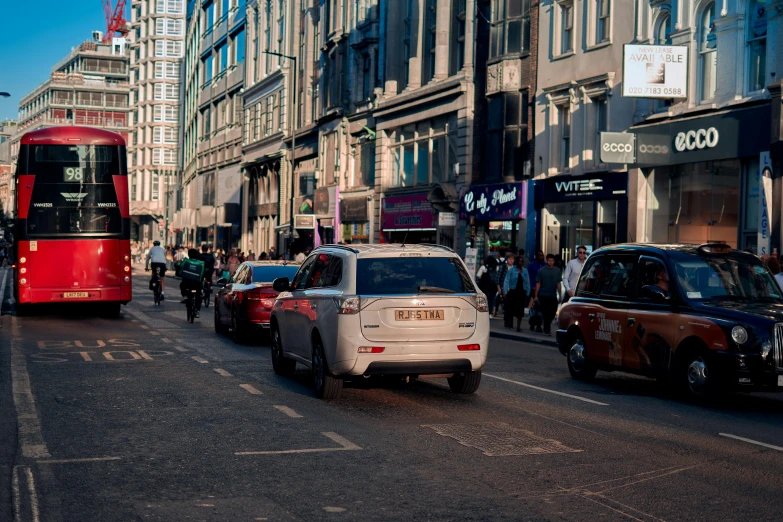 a red city bus riding down a busy street