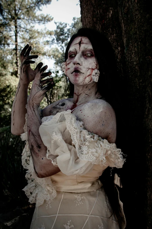 a woman is wearing zombie makeup and holds her hands out