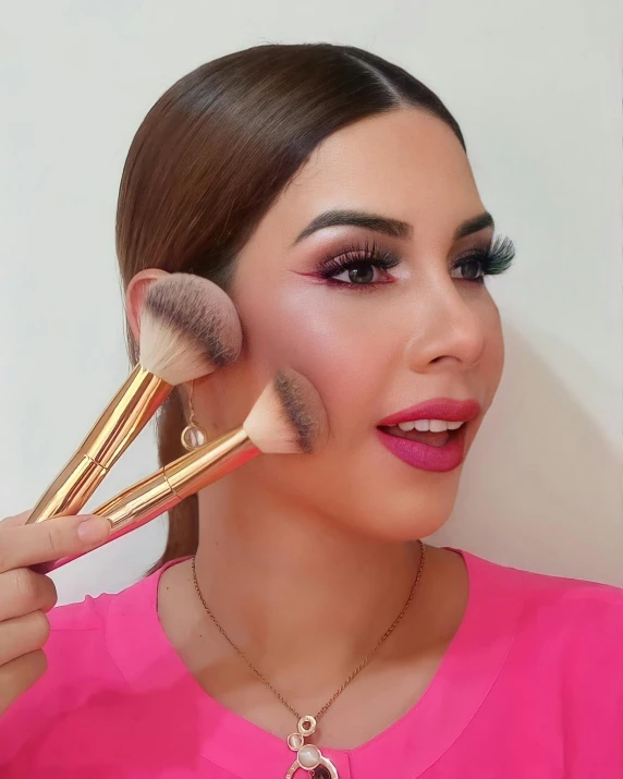 woman with two brushes for makeup on her face