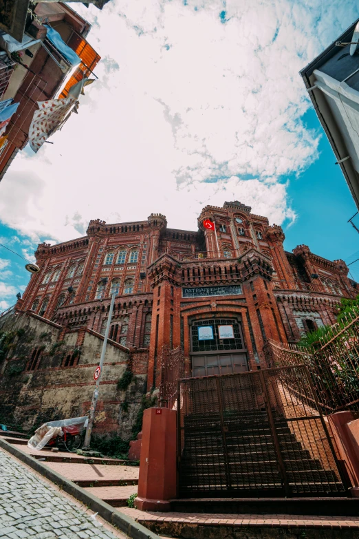 a very tall brick building sitting under a bright blue sky